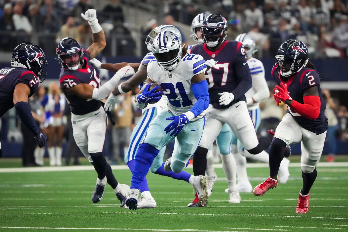 Dallas Cowboys running back Ezekiel Elliott (21) runs through the Houston Texans defense...