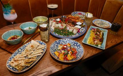 The food at Saaya includes the Dip Trio, Saaya Ultimate Feast, chicken kabob and Greek salad.