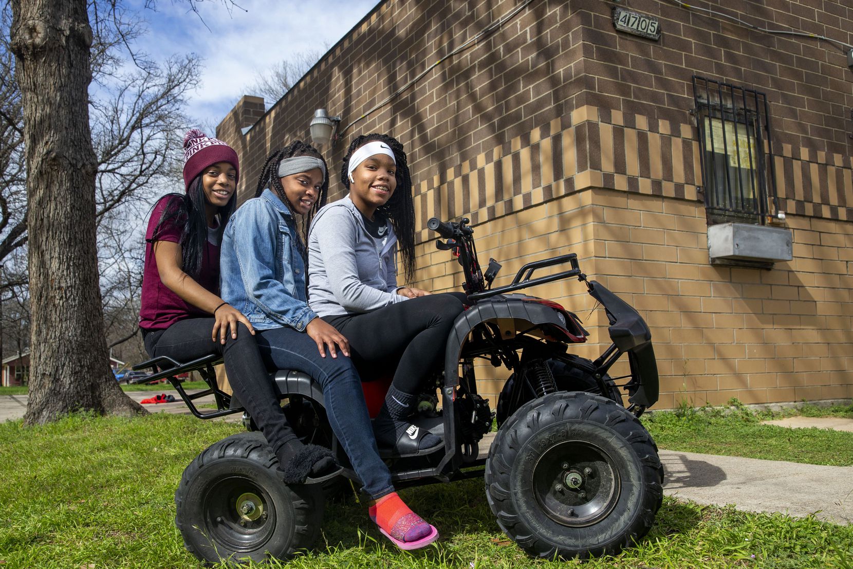 Kimberly Jones, 16; Kennadie Hall, 13; and Miracle Pride, 14, hang out on an all-terrain...