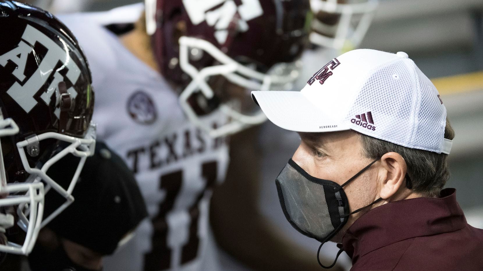 Texas A&M head coach Jimbo Fisher prepares to take the field with his players before a game...