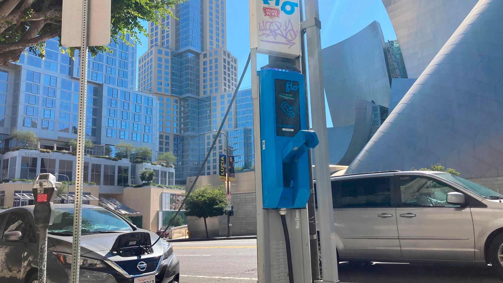 An electric vehicle charges on a pole-mounted charger in Los Angeles on Oct. 4, 2022. EV...