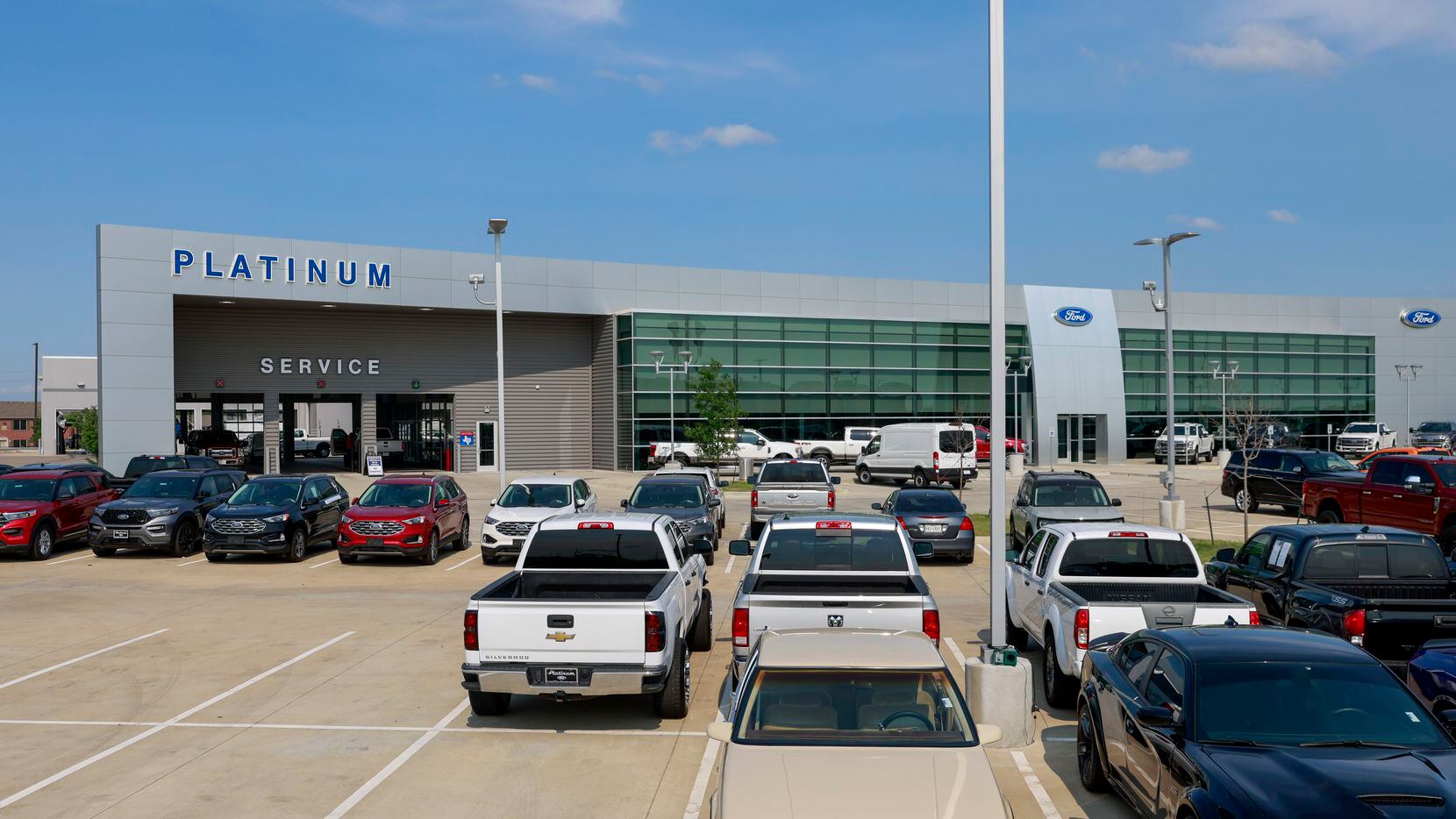 Pre-owned vehicles sit in a lot at Platinum Ford in Terrell in May.  Scott Burns expects a...