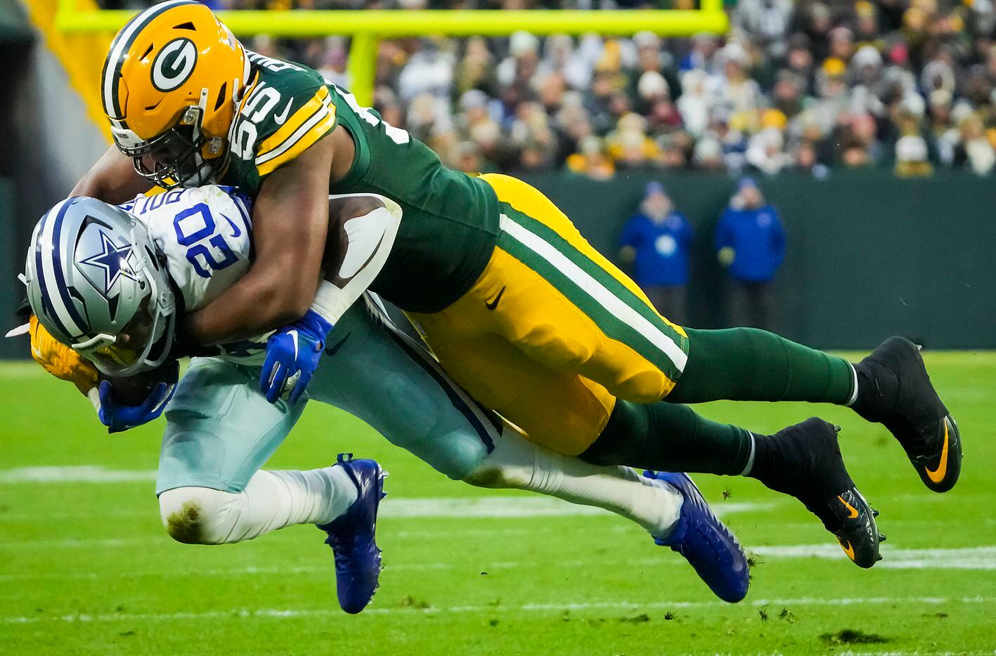 Dallas Cowboys running back Tony Pollard (20) is brought down by Green Bay Packers...