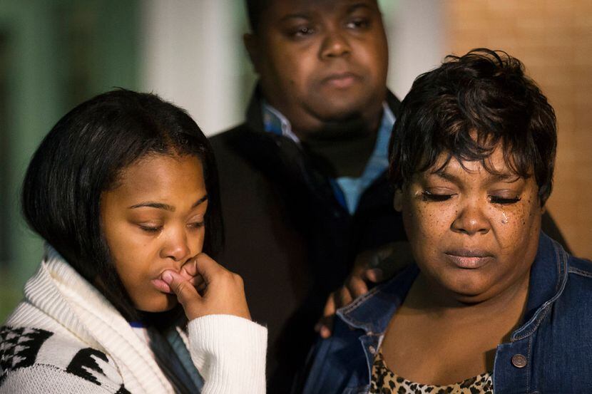 A tear rolls down the cheek of Jacqueline Craig (right) as she attends a press conference...
