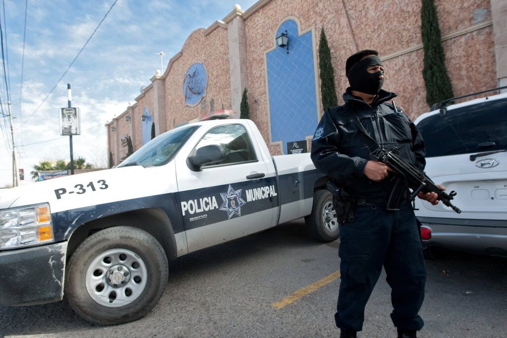 A member of the local police guards one of the hotels where policemen are billeted on January 31, 2012 in Ciudad Juarez, Chihuahua state, Mexico. 