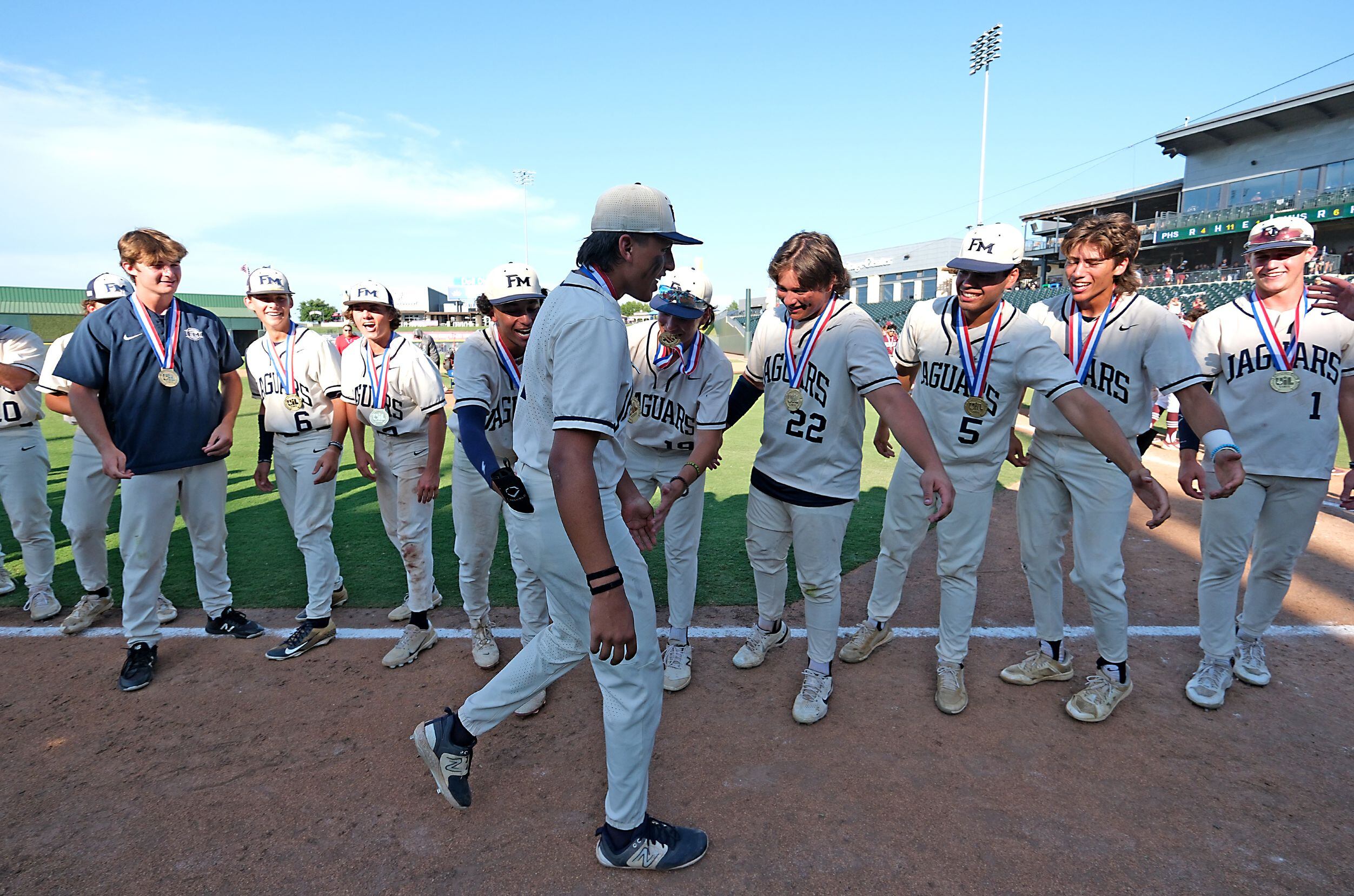Flower Mound team members celebrate with Adrian Rodriguez, (2), after he was selected MVP of...