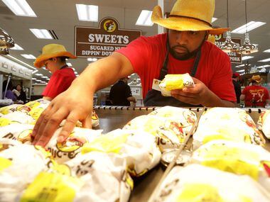 Eric Thomas stocks the Bacon Egg & Cheese Croissants at the new Buc-ee's in Melissa, TX, on...