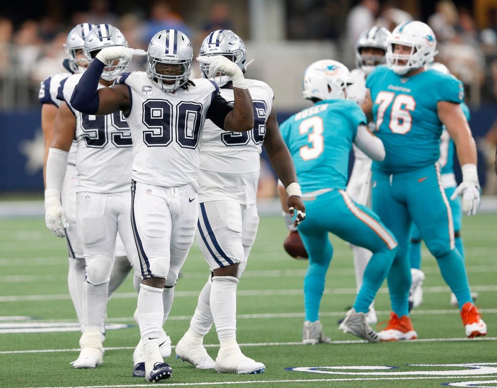 FILE - Cowboys defensive end DeMarcus Lawrence (90) celebrates a sack during the second half of a game against the Dolphins at AT&T Stadium in Arlington on Sunday, Sept. 22, 2019.