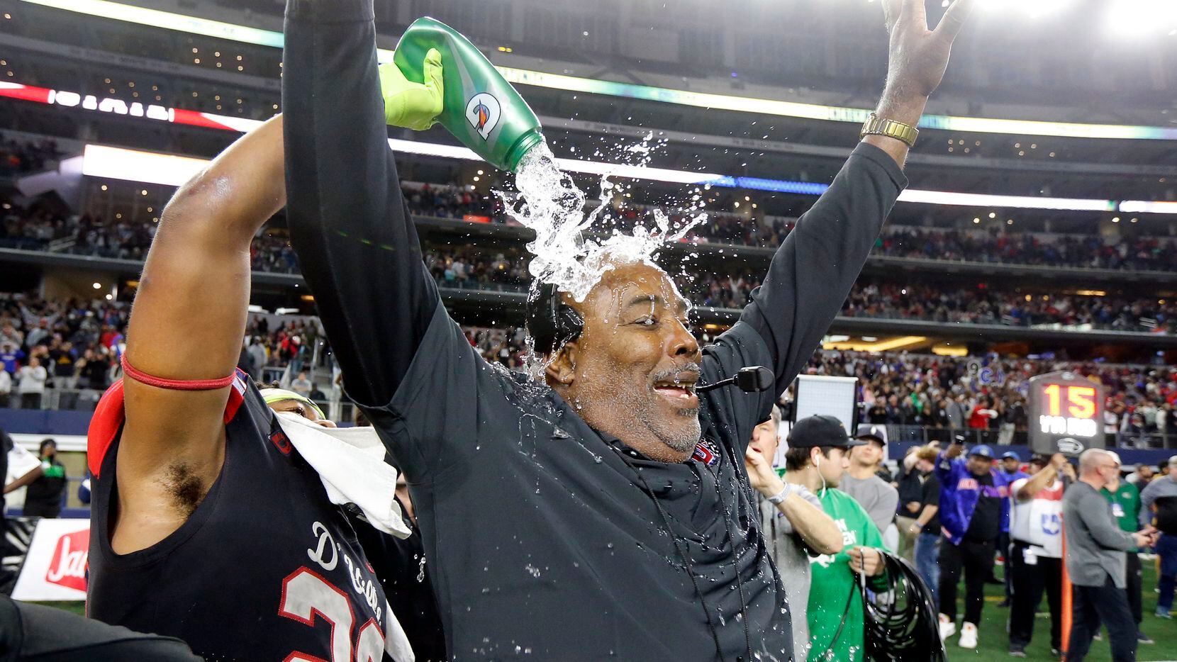 Duncanville head coach Reginald Samples is doused with water as he celebrates their Class 6A...