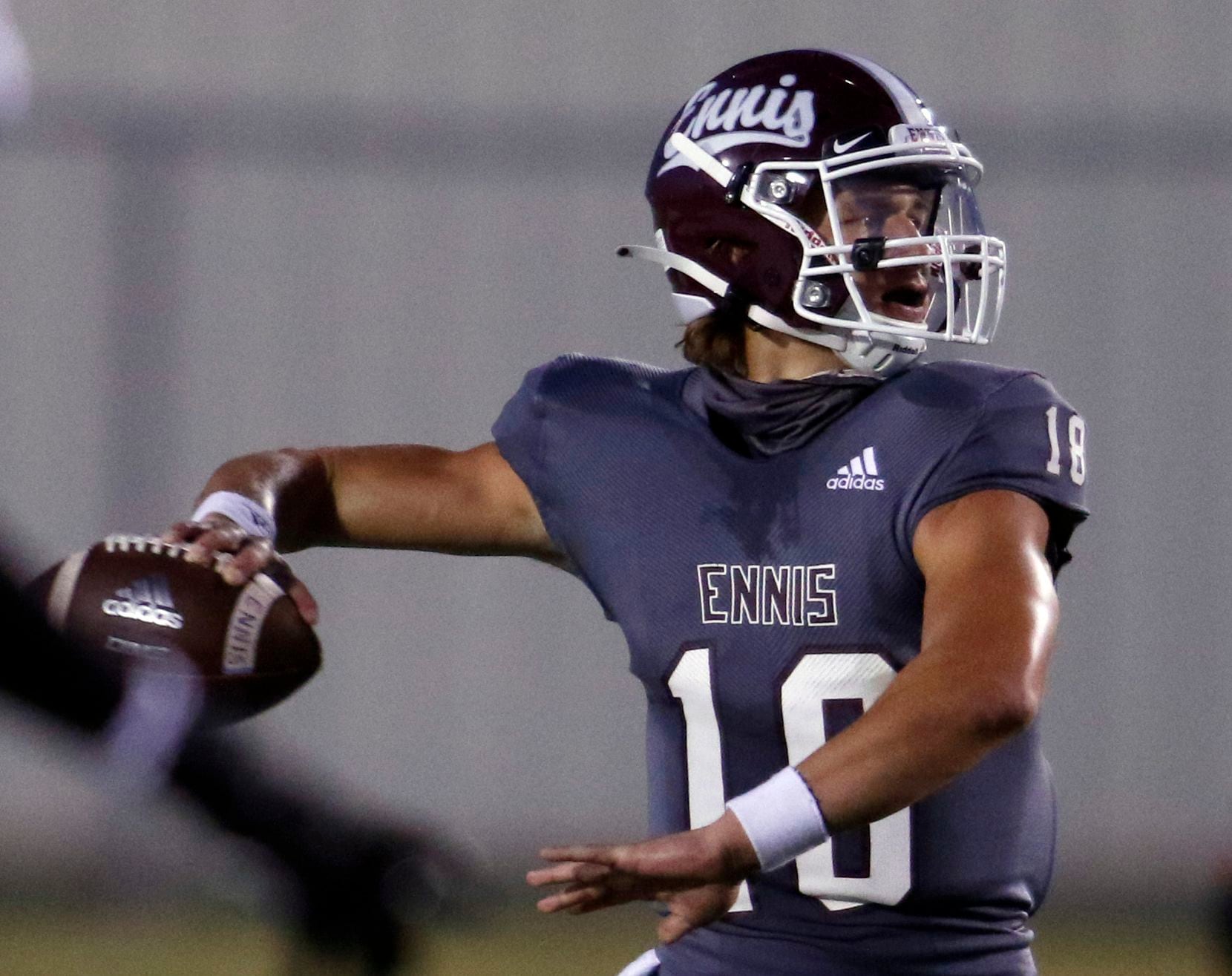 Ennis quarterback Collin Drake (18) prepares to pass downfield during first quarter action...