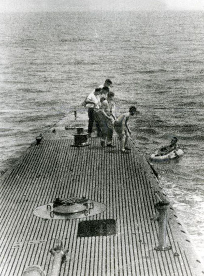 1944: Navy pilot George Bush (right) is pulled from the ocean by sailors onboard the Navy...