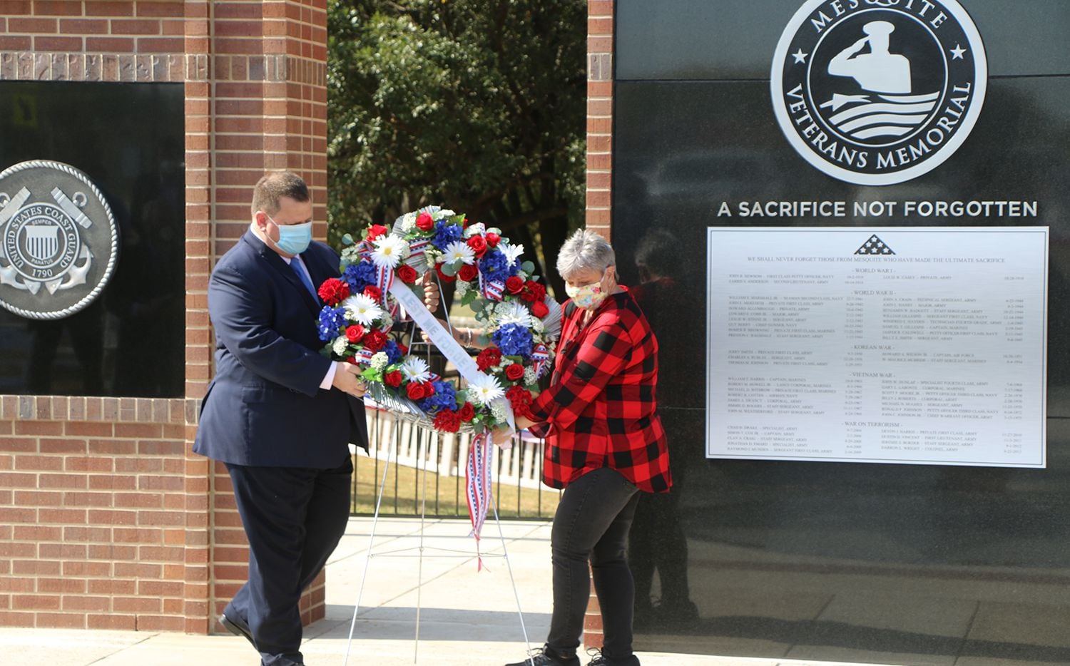 Gold Star mother Mary Border and Mesquite Mayor Bruce Archer lay a memorial beneath the...