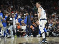 Dallas Mavericks guard Luka Doncic celebrates after hitting a 3-pointer during the second...