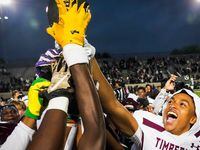 Mansfield Timberview players, including defensive back Jordan Sanford (right) celebrate with...