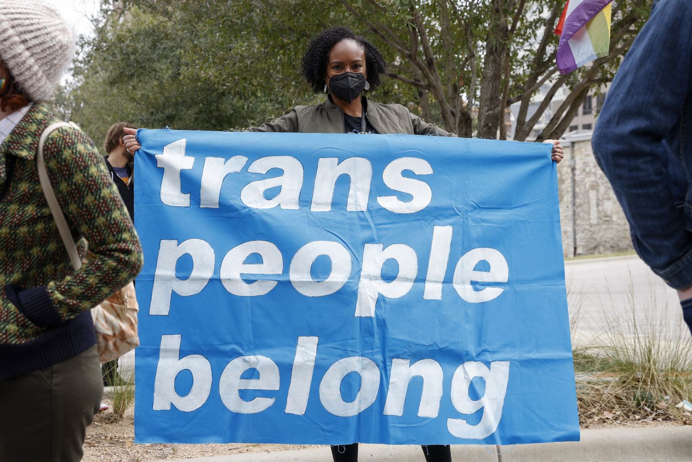 Oni Blair, ACLU of Texas executive director, holds a banner during the "Trans Kids Cry For...