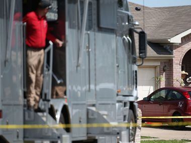 Denton County Sheriff's officers investigate a crime scene where five people were killed and...