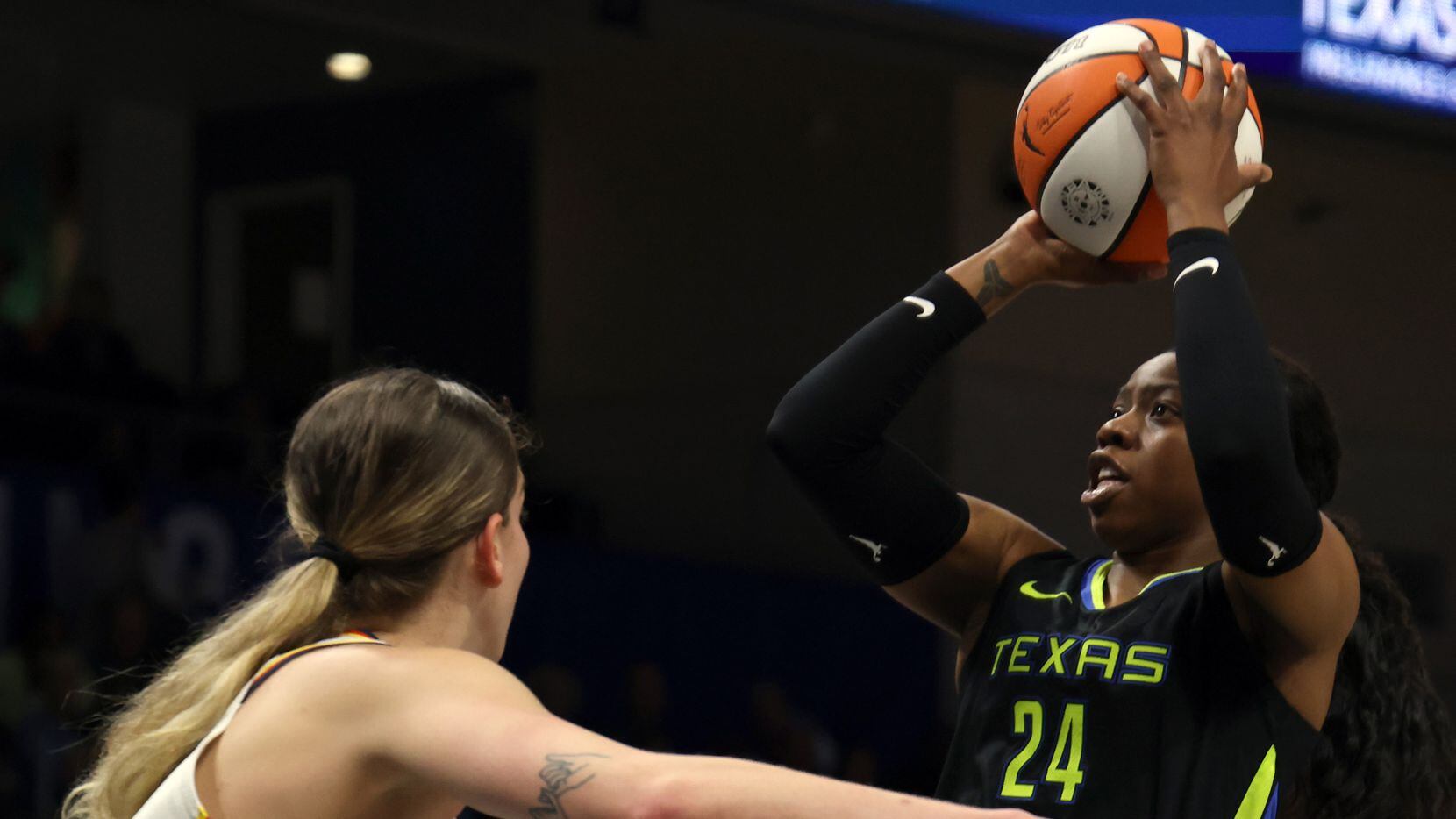 Dallas Wings guard Arike Ogunbowale (24) shoots over the defense of Indiana Fever forward...