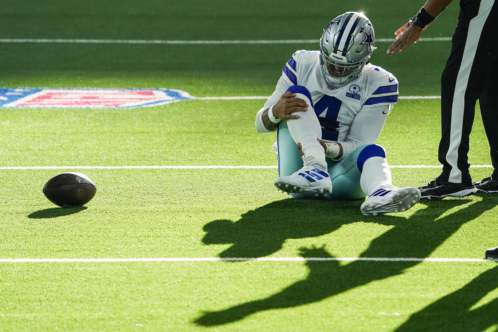 Dallas Cowboys quarterback Dak Prescott waits for medical attention after being injured on a tackle by New York Giants cornerback Logan Ryan during the third quarter of an NFL football game at AT&T Stadium on Sunday, Oct. 11, 2020, in Arlington. Prescott was injured o the play when Ryan came down on his right leg and left the game. (Smiley N. Pool/The Dallas Morning News)