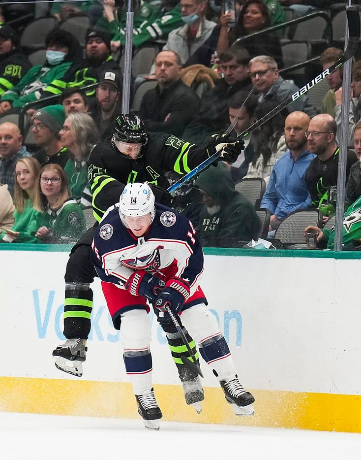 Dallas Stars defenseman Esa Lindell (23) collides with Columbus Blue Jackets center Gustav Nyquist (14) during the first period of an NHL hockey game at the American Airlines Center on Thursday, Dec. 2, 2021, in Dallas.