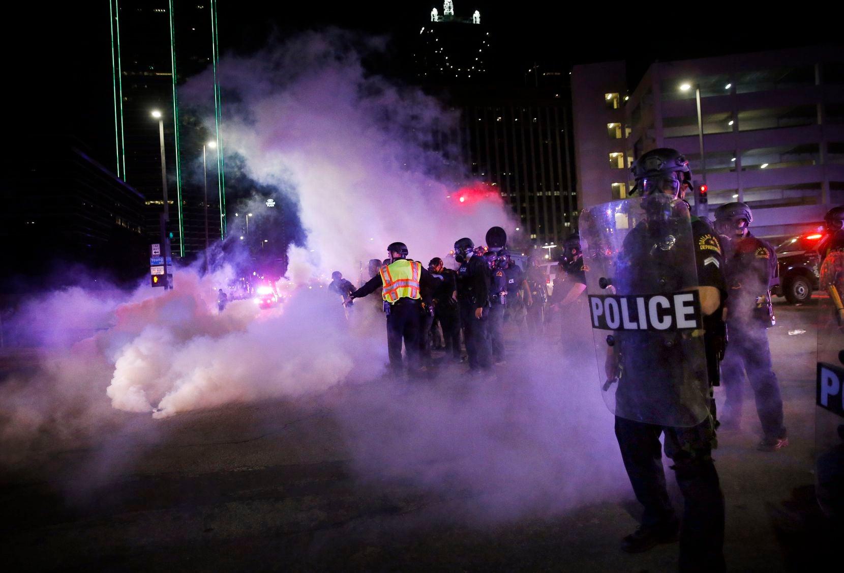 Dallas Police tactical officers face off with protesters at Young and S. Griffin streets in...