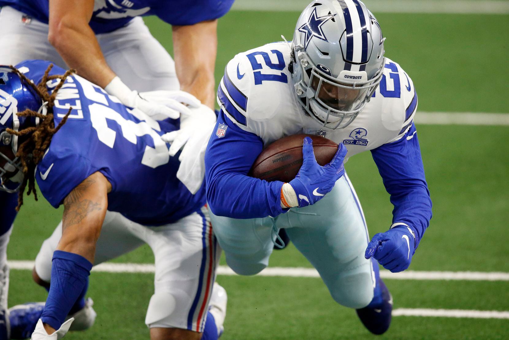 Dallas Cowboys running back Ezekiel Elliott (21) is hit by New York Giants running back Dion Lewis (33) after making a catch during the first quarter at AT&T Stadium Stadium in Arlington, Texas, Sunday, October 11, 2020. (Tom Fox/The Dallas Morning News)