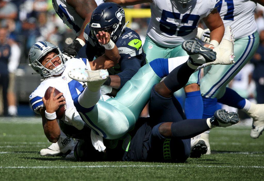 Dallas Cowboys quarterback Dak Prescott (4) is sacked by Seattle Seahawks defensive tackle...