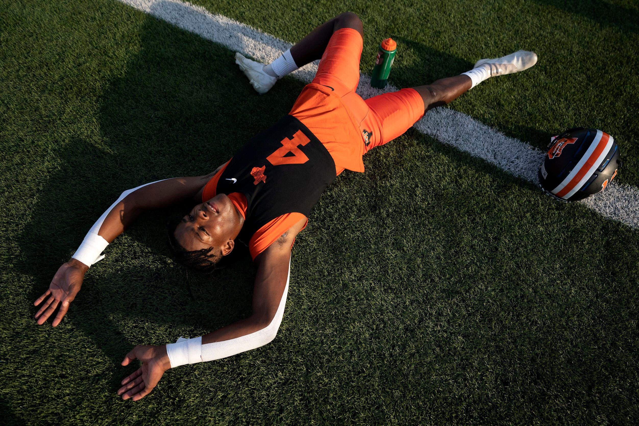 Lancaster wide receiver Dwight Jones (4) stretches before a high school football game...