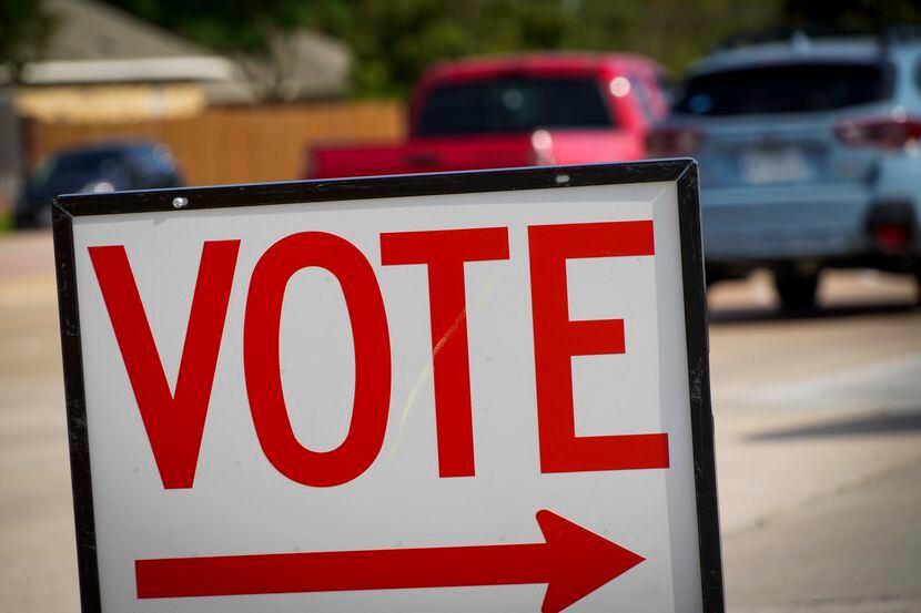 Traffic passes a polling place sign outside a Collin County early voting location at...