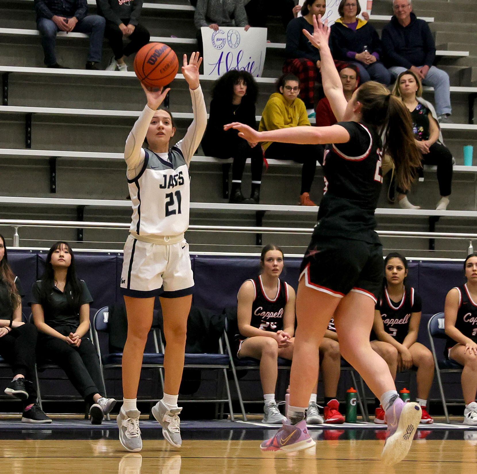 Flower Mound guard Kaitlyn Meche (21) attempts a three point shot against Coppell guard...