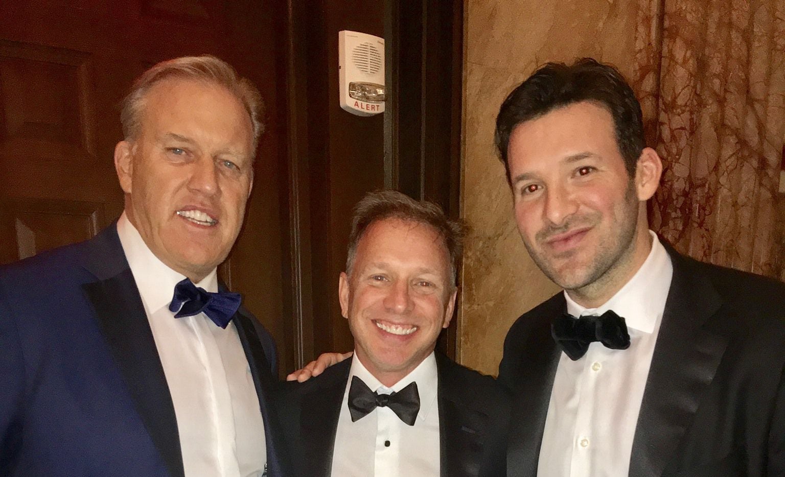 Broncos vice president and general manager John Elway (L), Tony Romo (R)