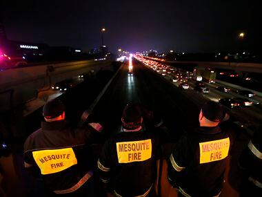 Firefighters from the Mesquite Fire Department salute as the procession of fallen Richardson...