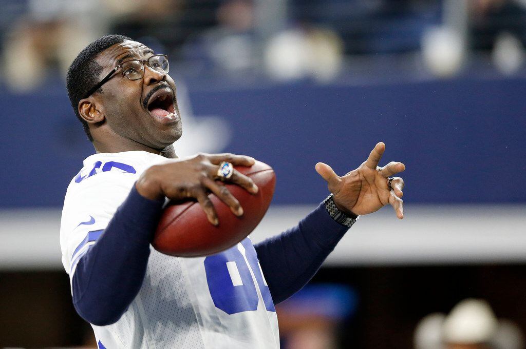 Dallas Cowboys former receiver Michael Irvin (88) plays catch with himself after being...