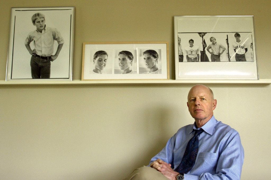 Robert A. "Bob" Wilson posed for a 2004 portrait in his Dallas office, beneath photos of his...