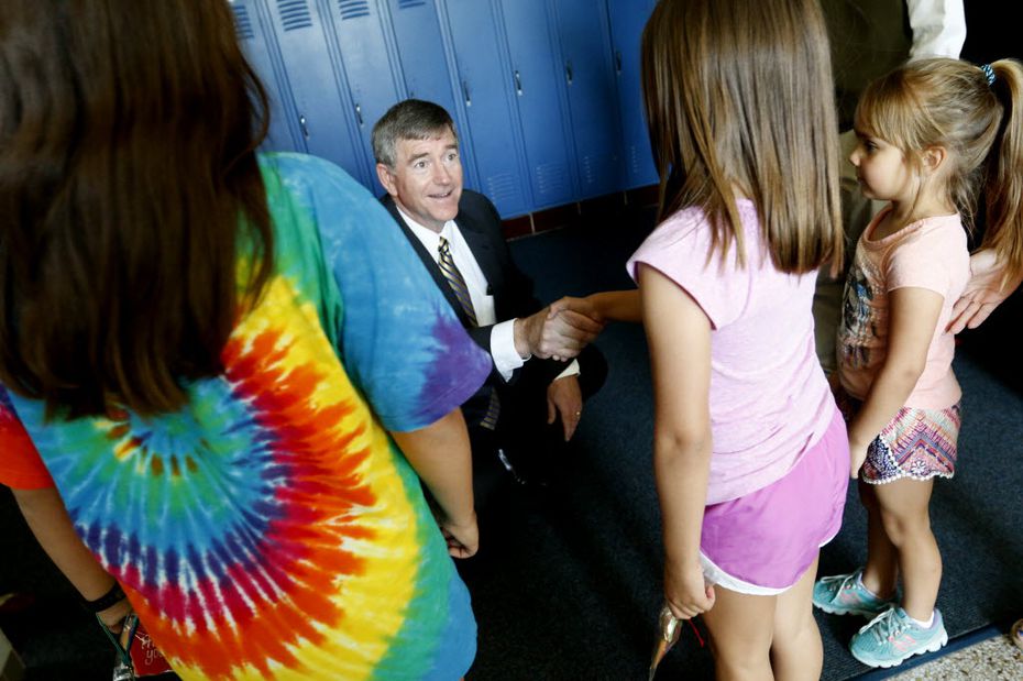 Highland Park Superintendent Tom Trigg introduces himself to students while touring...