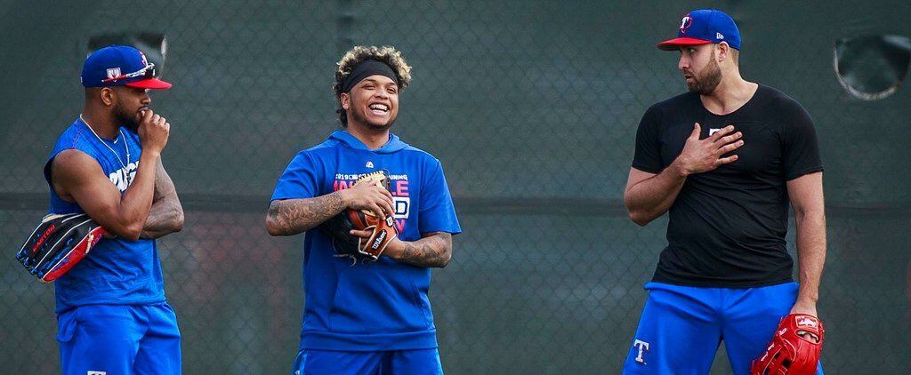 Texas Rangers outfielder Willie Calhoun (center) laughs with Delino DeShields (left) and...