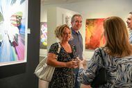 Kelly Skinner (left) speaks with staff office coordinator Laura Willwerth alongside husband...