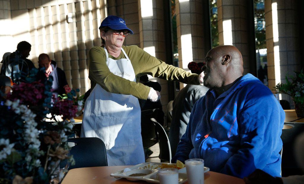 Johnson dances for guest Frank Pineset.  The cafe serves about 1,000 people daily, seven...
