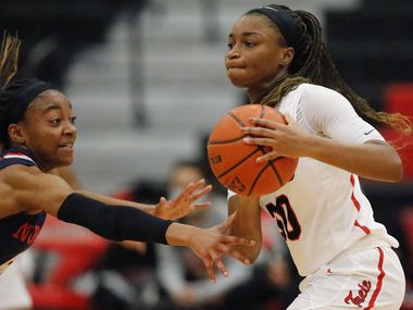 Frisco Liberty High School guard Jazzy Owens-Barnett (30) makes a pass while defended by...