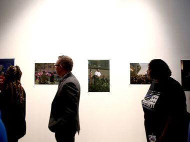 People view a gallery of images submitted by El Centro students during the Renewal and...