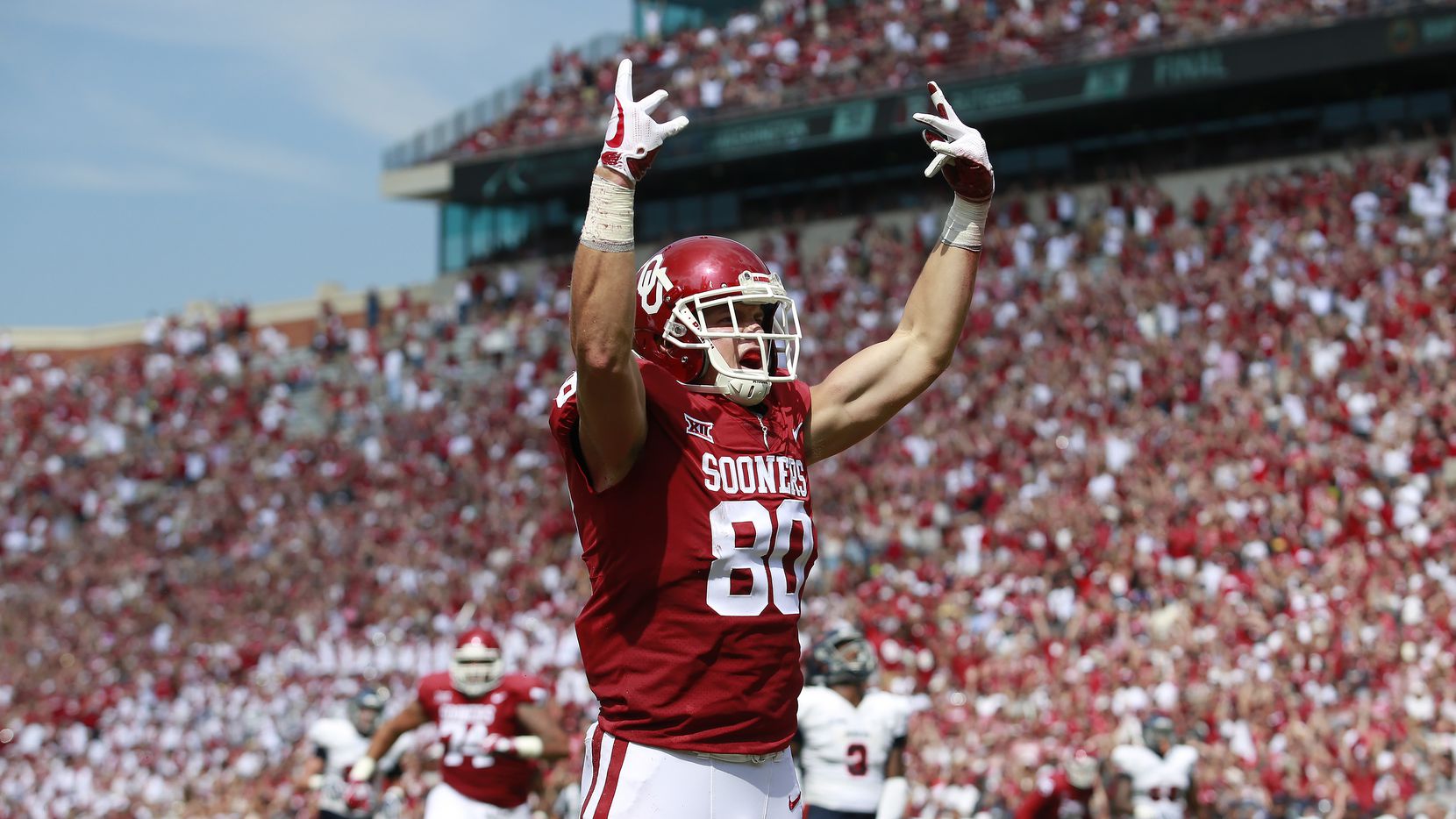 Tight end Grant Calcaterra #80 of the Oklahoma Sooners celebrates a touchdown against the...