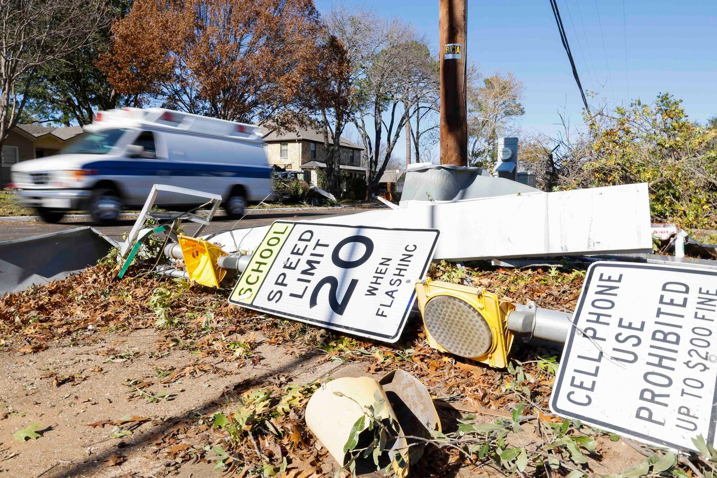Traffic pass along Lucas Dr. in Grapevine past tornado damages on Wednesday, Dec. 14, 2022,...