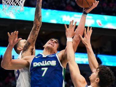 Dallas Mavericks center Dwight Powell (7) is fouled as he tries to drive to the basket...