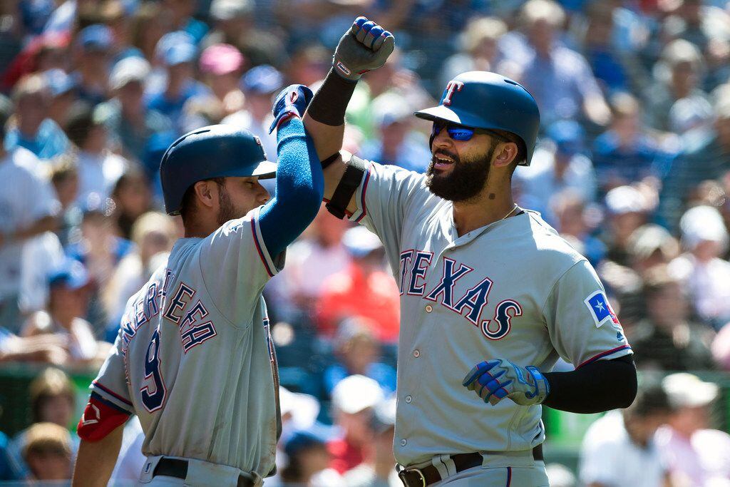 Texas Rangers' Nomar Mazara, right, celebrates his solo home run with teammate Isiah...