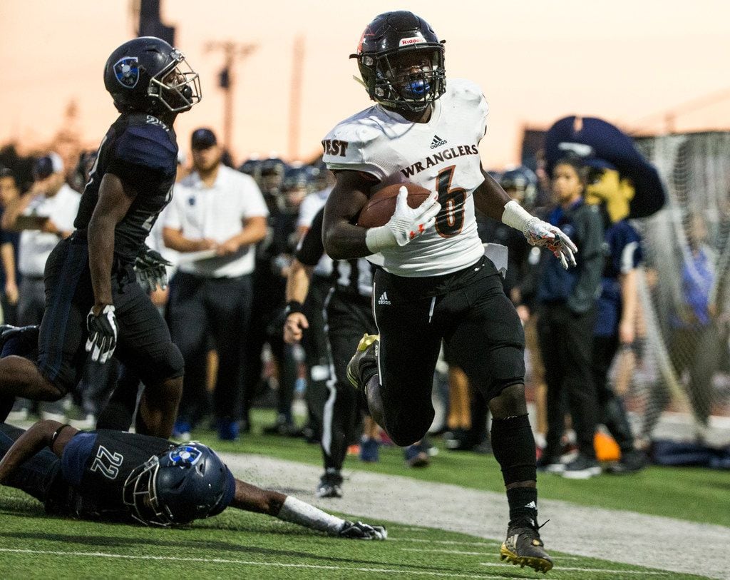 West Mesquite's Ty Jordan (6) scores a touchdown during a football game between West...
