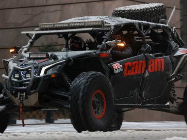 A person drives a Can-Am ATV with other motorist through downtown, Wednesday, Feb. 1, 2023,...