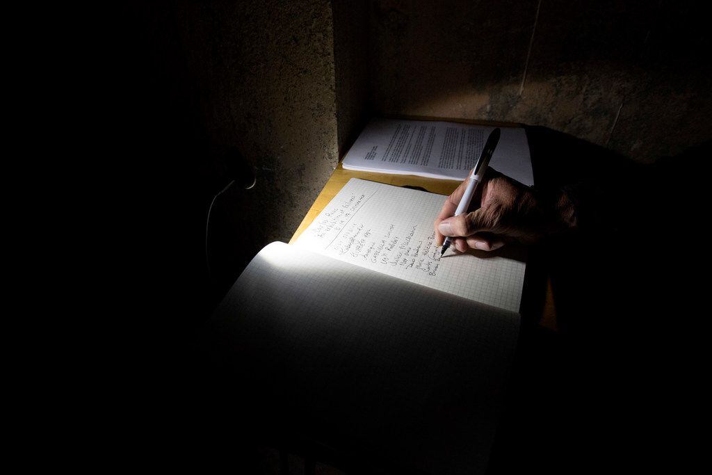 A patron signs a guestbook at The Power Station art gallery, which includes a 44-square-foot...