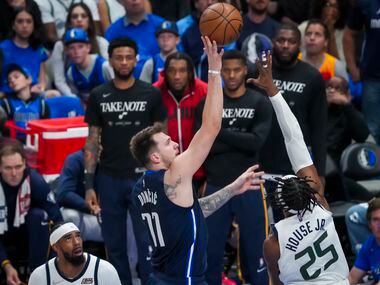 Dallas Mavericks guard Luka Doncic (77) shoots over Utah Jazz forward Danuel House Jr. (25)...