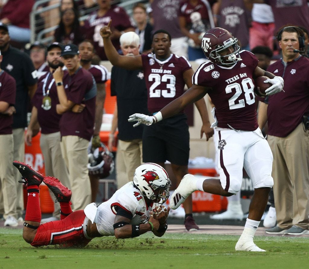 COLLEGE STATION, TEXAS - SEPTEMBER 14: Isaiah Spiller #28 of the Texas A&M Aggies is tackled from behind by Michael Lawson #41 of the Lamar Cardinals during the second quarter at Kyle Field on September 14, 2019 in College Station, Texas. (Photo by Bob Levey/Getty Images)