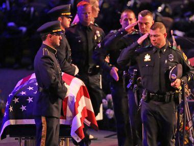 Dallas officers pay their final respects to slain colleague Rogelio Santander at the funeral...