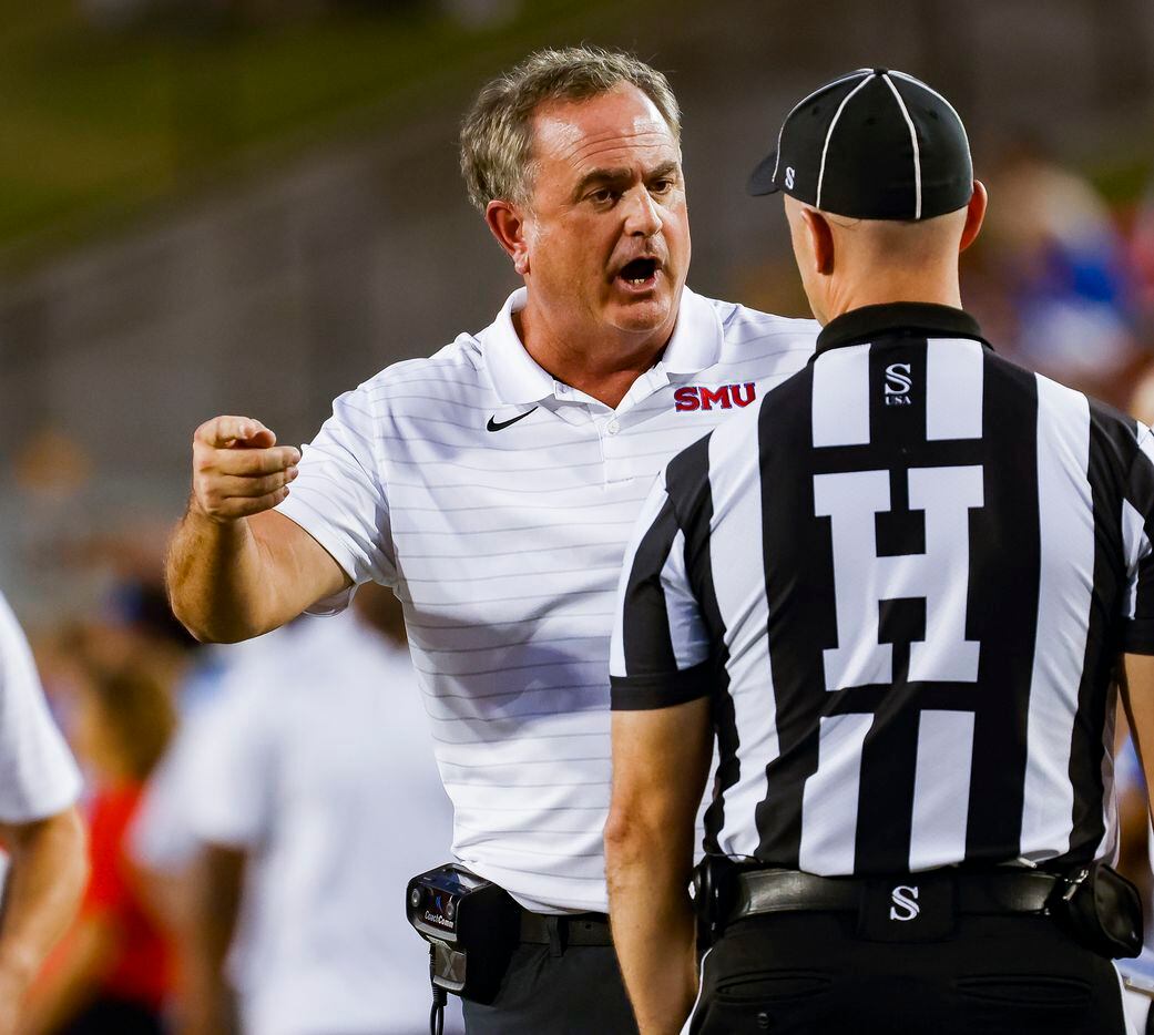 SMU head coach Sonny Dykes talks to refs as they review Southern Methodist Mustangs...